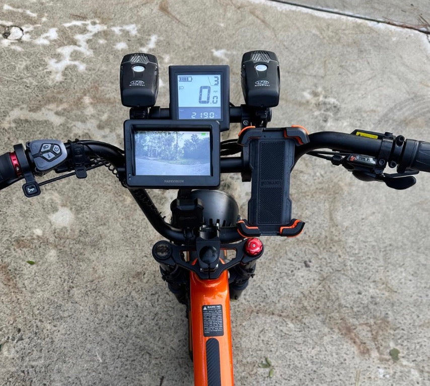 Rider climbing a steep hill on a fat-tire folding e‑bike