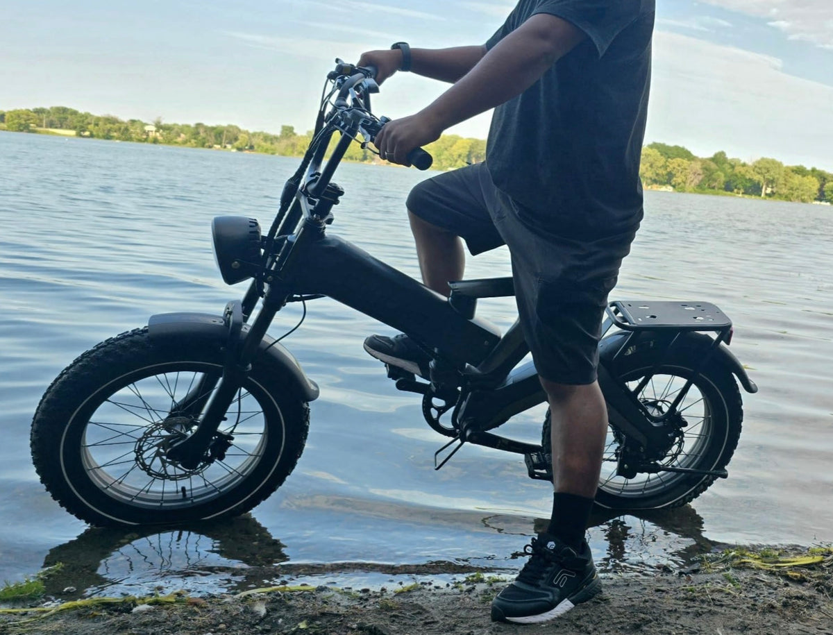 Commuter riding an e‑bike past downtown buildings